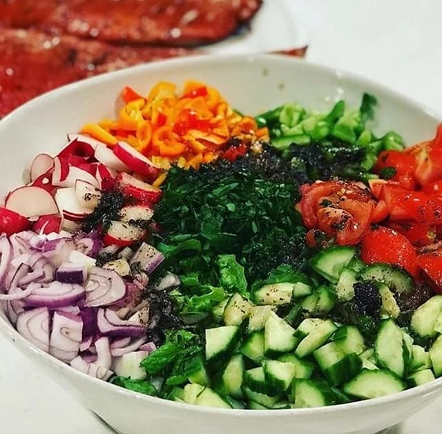 A fresh Lebanese salad of cucumbers, tomatoes, radish, peppers and herbs prepared by Al-Amir