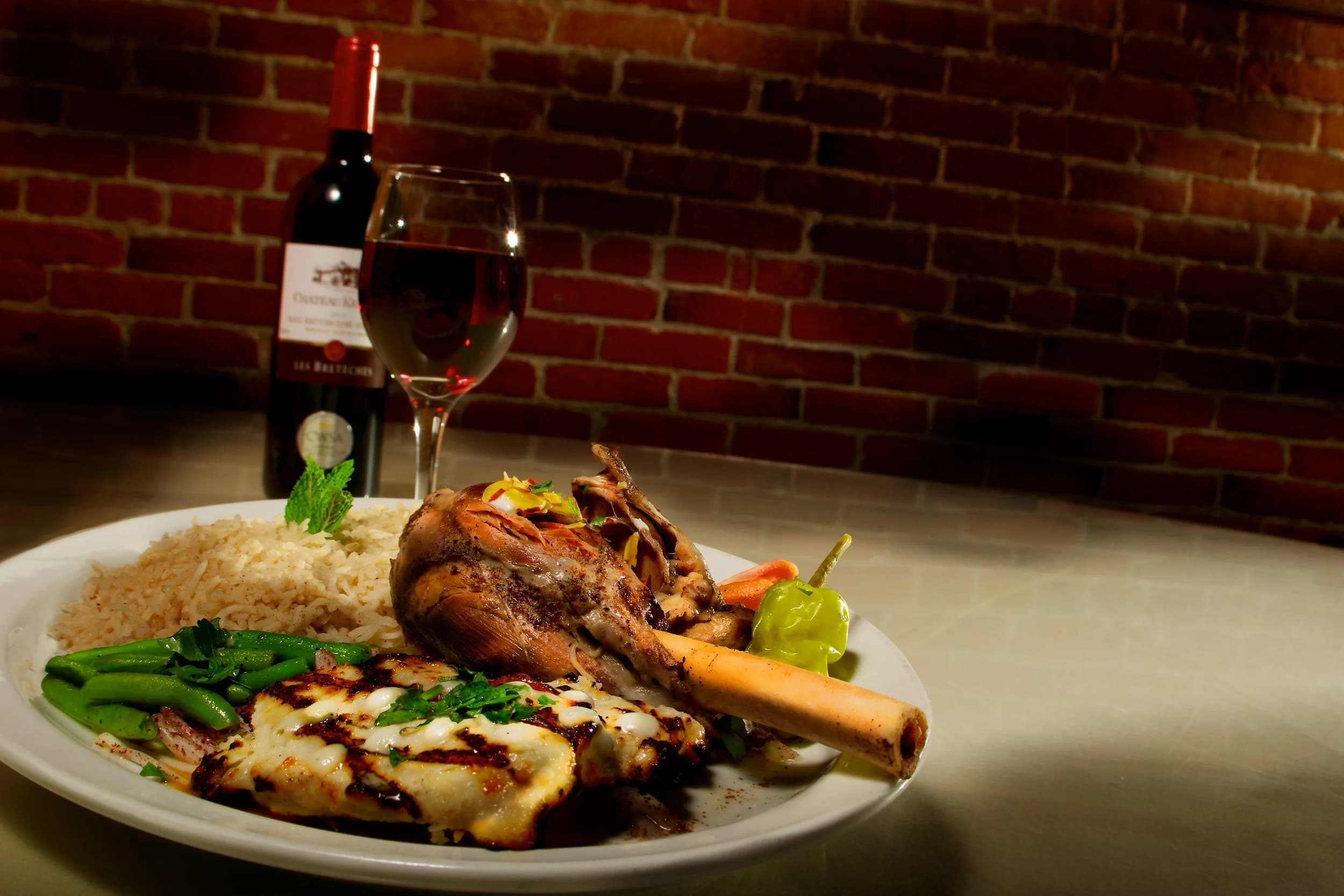 Kharouf Mohammar — slow-roasted lamb shank with basmati rice and Lebanese red wine at Al-Amir in Portland